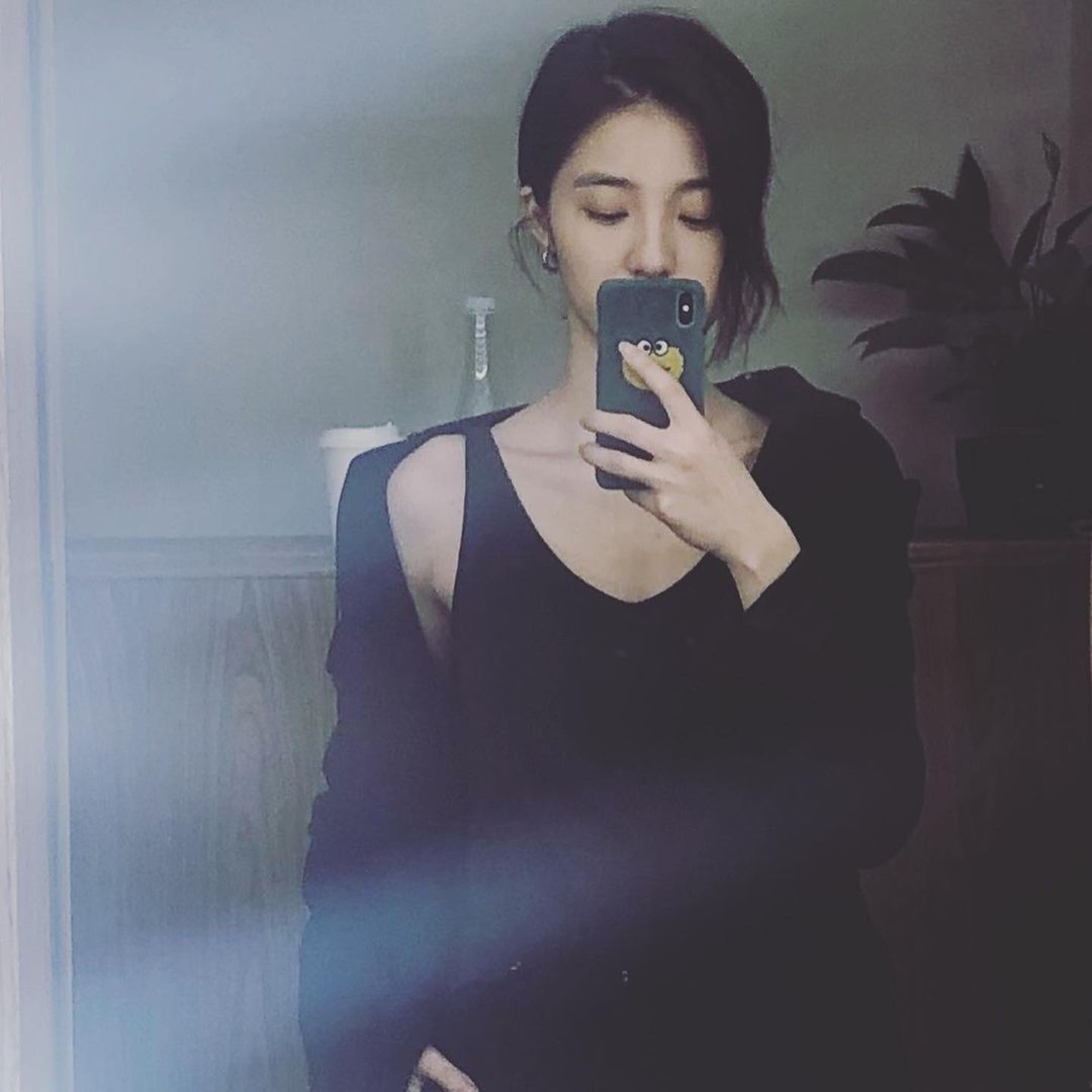 Wan Peng taking mirror selfie in black dress