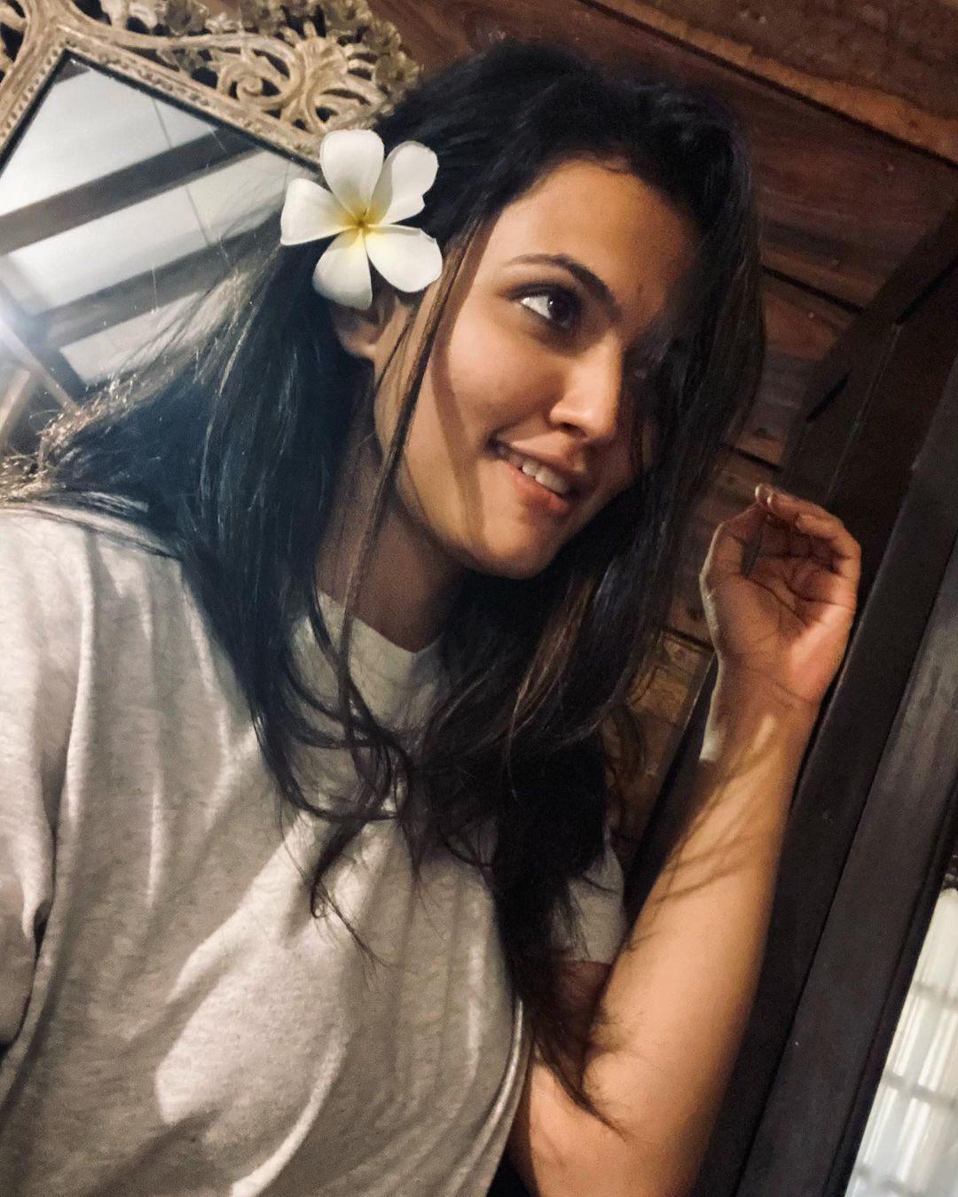 Actress Aparna Das with a white flower in the hair