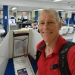 Whitney Tilson in red t-shirt at a polling station