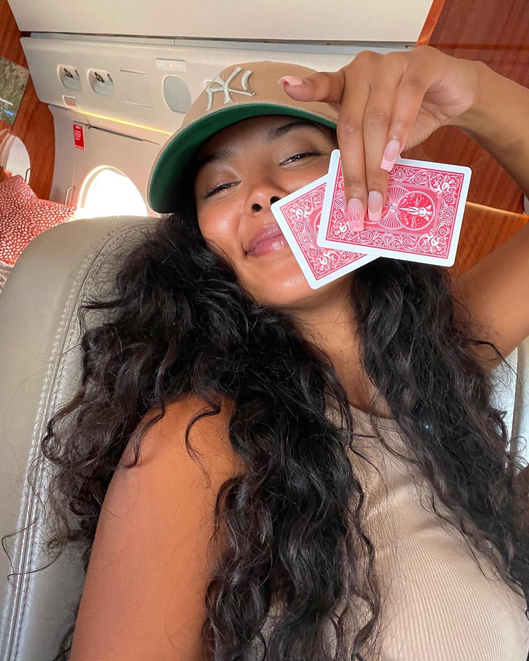 Maya Jama with a pair of cards in hand