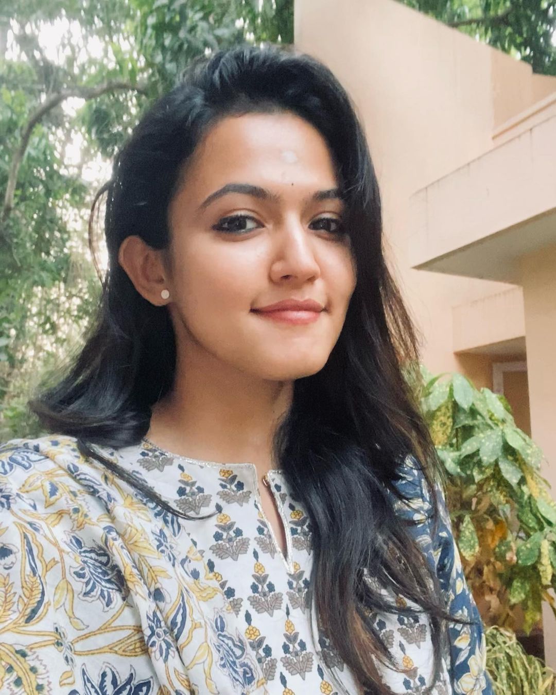 Aparna Das in floral top and open hair 