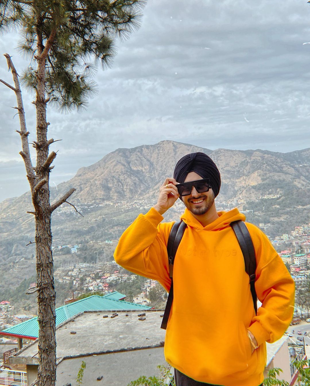 Rohanpreet Singh in yellow hoodie and black goggles enjoying in mountains