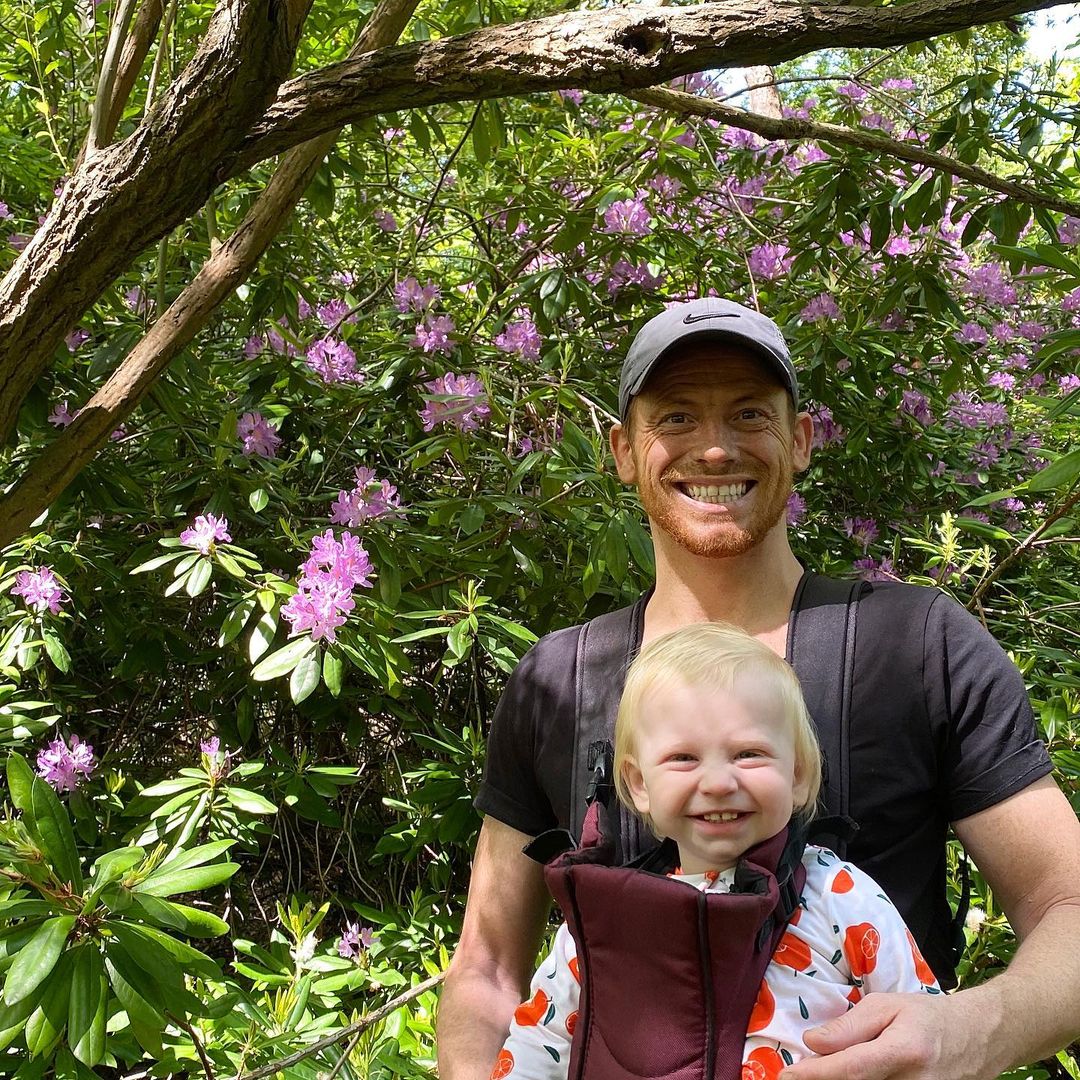 Joe Swash in black t-shirt with his son