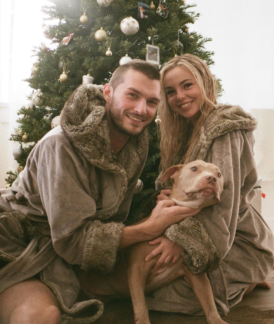 Emma Kotos and Brandon Gray with their pet