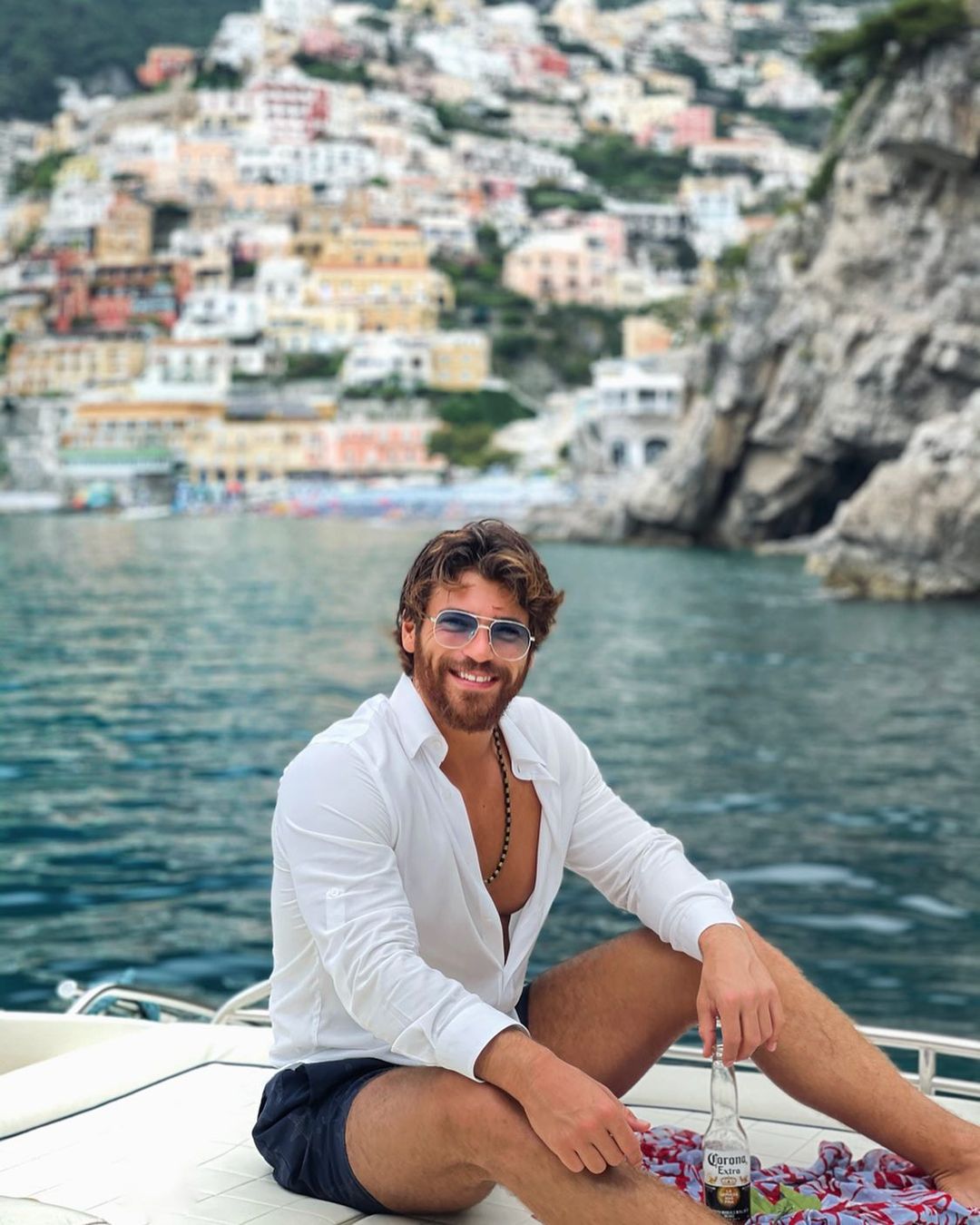 Can Yaman in white shirt enjoying on a boat
