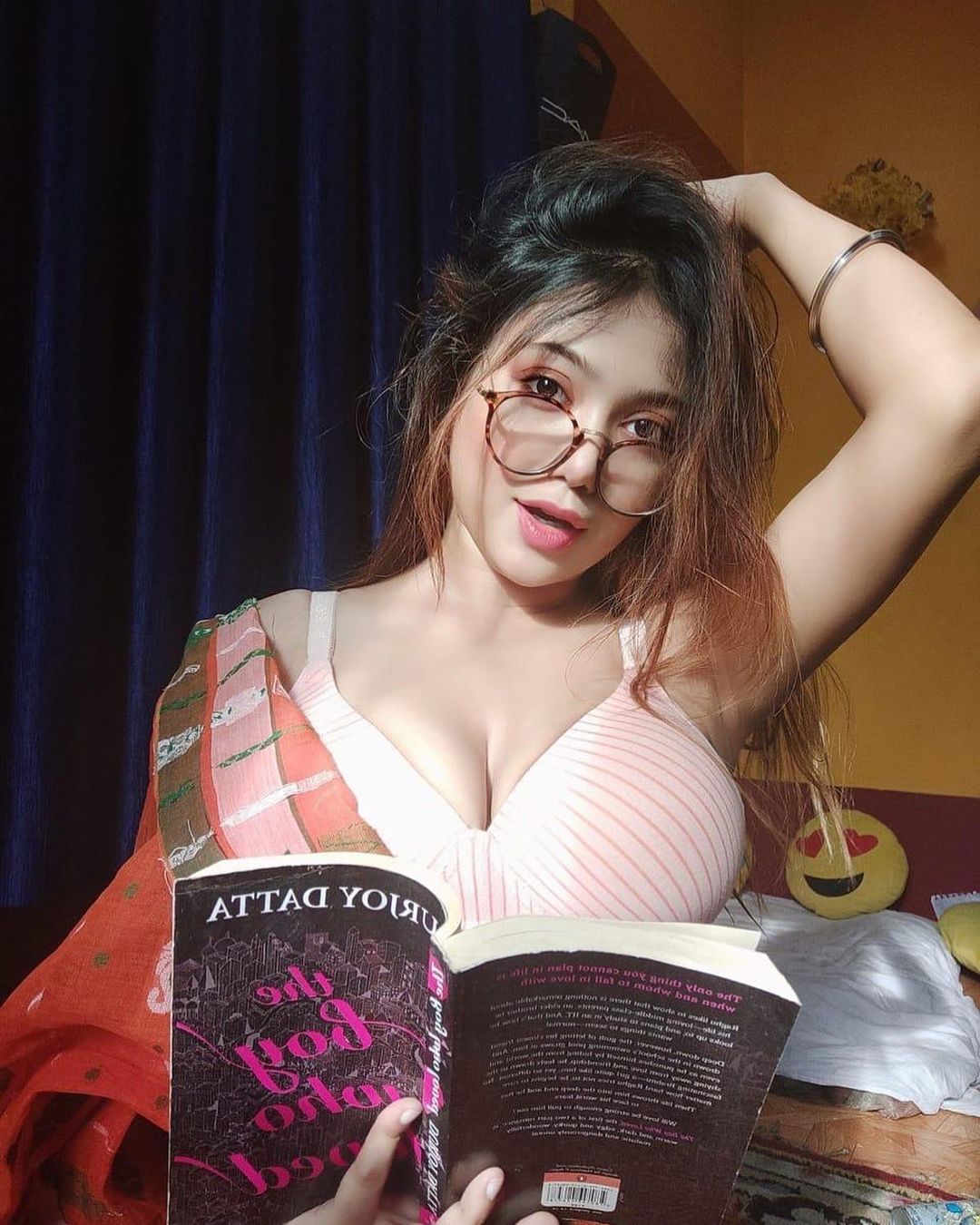 Lovely Ghosh holding a book in a sensual saree look