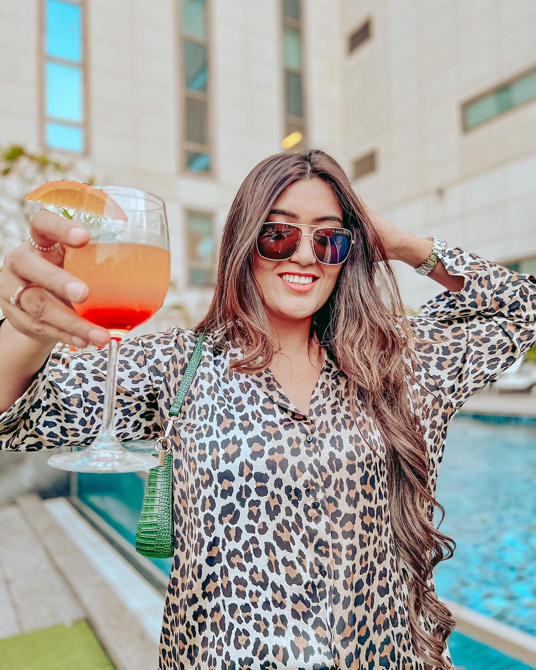 Shireen Mirza in leopard shirt and holding a glass of juice