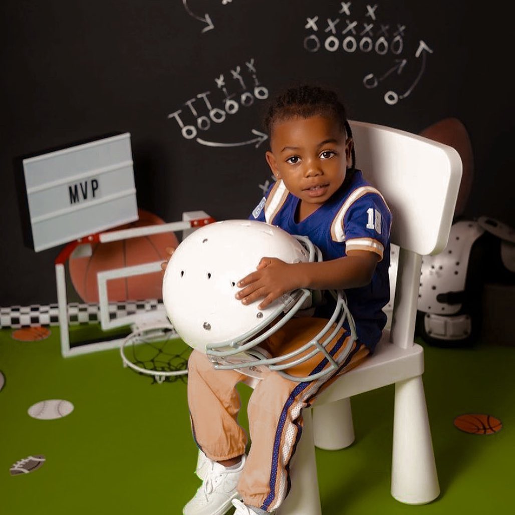 Taylin Gaulden with a white helmet on his lap