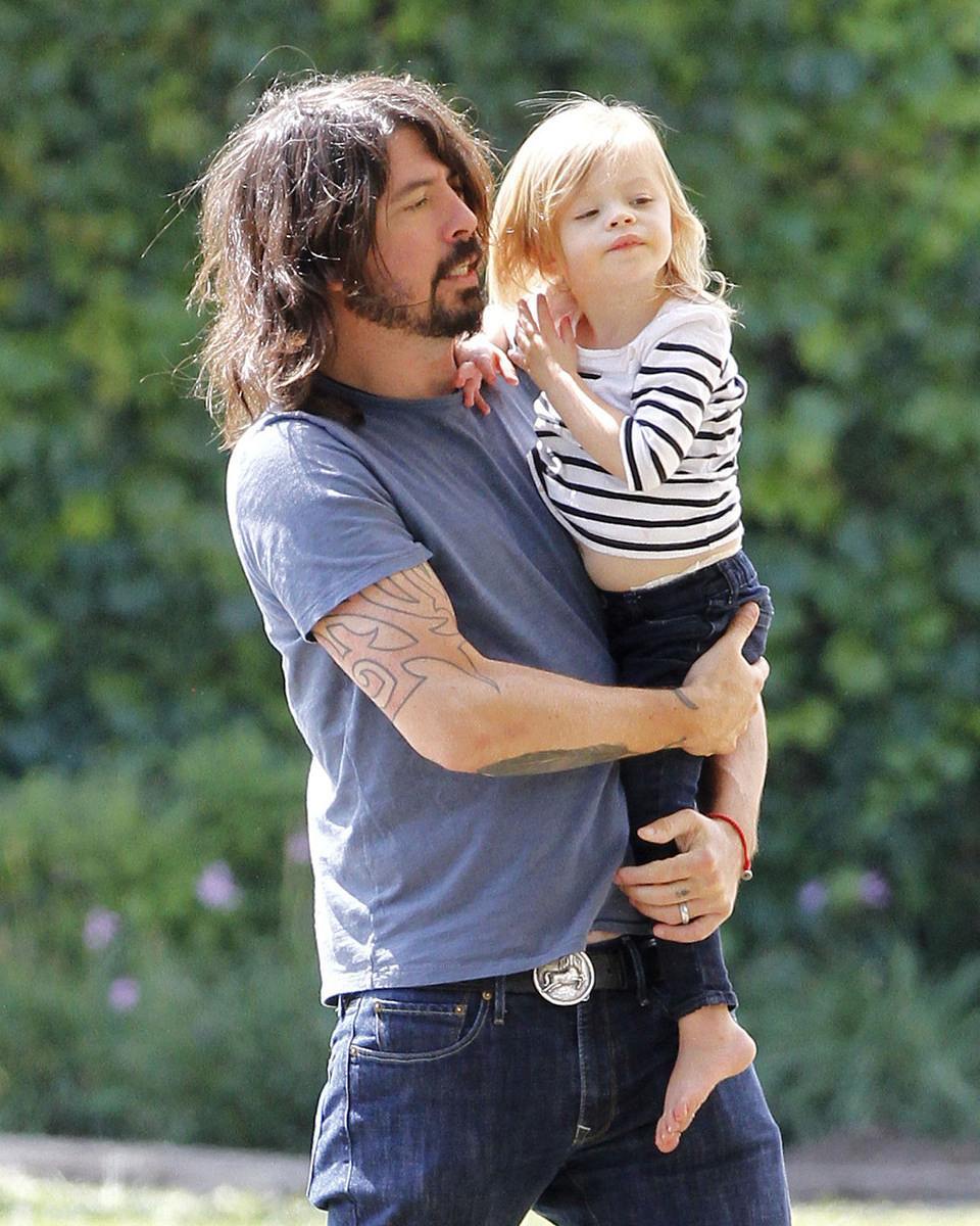 Dave Grohl holding Harper Grohl on his body