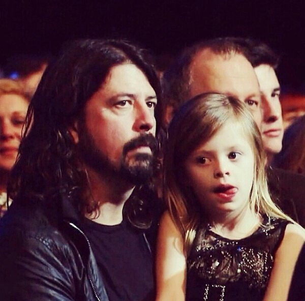 Harper Grohl in black dress with his father