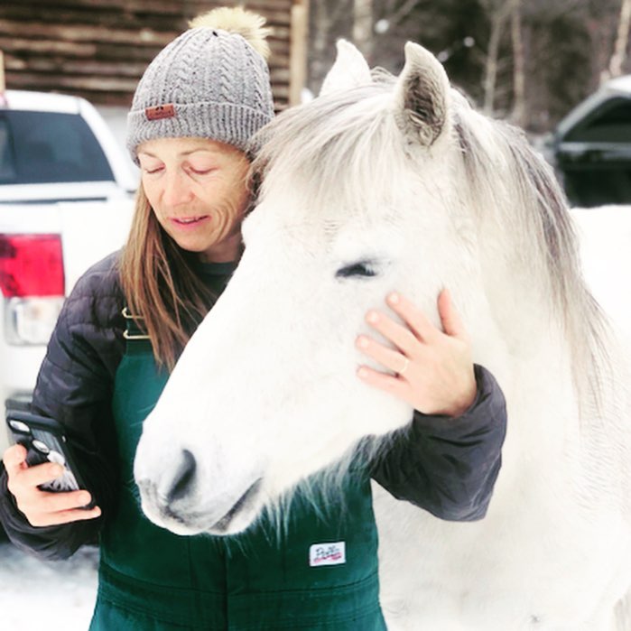Dr. Michelle Oakley with a white horse