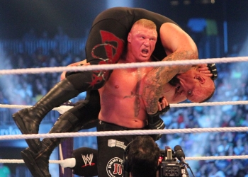 Duke LBrock Lesnar holding Undertaker on his shoulders in WWE Ring