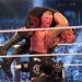 Duke LBrock Lesnar holding Undertaker on his shoulders in WWE Ring