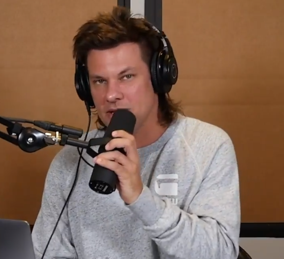 Theo Von Podcasting in grey t-shirt