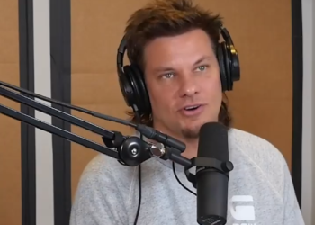 Theo von doing podcast in grey t-shirt