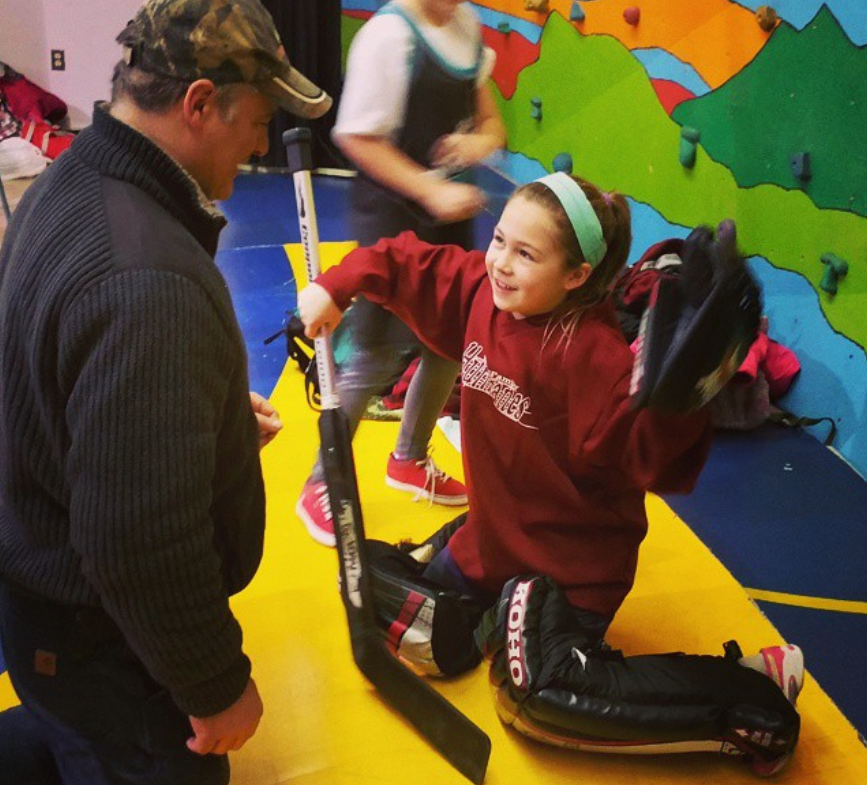 Willow Oakley with her father at floor hockey