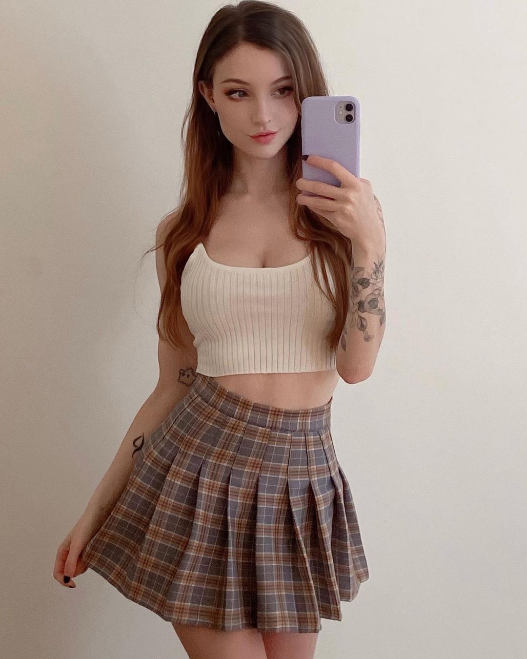 Dainty Wilder in cream crop top and checked mini skirt