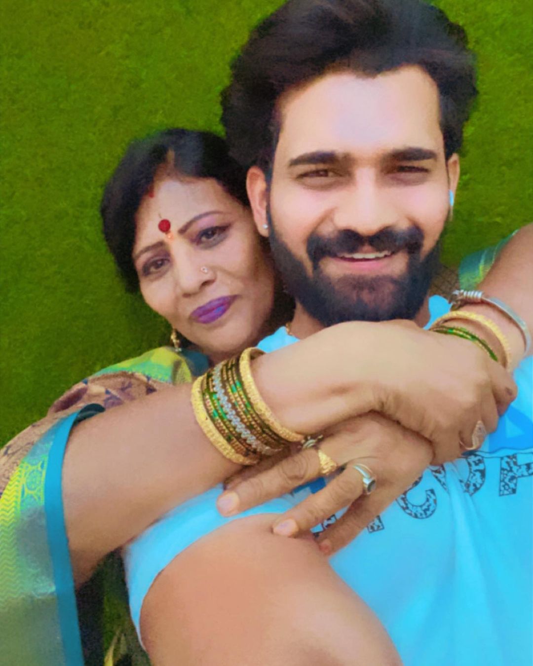 Akhil Sarthak with his mother hugging him from behind