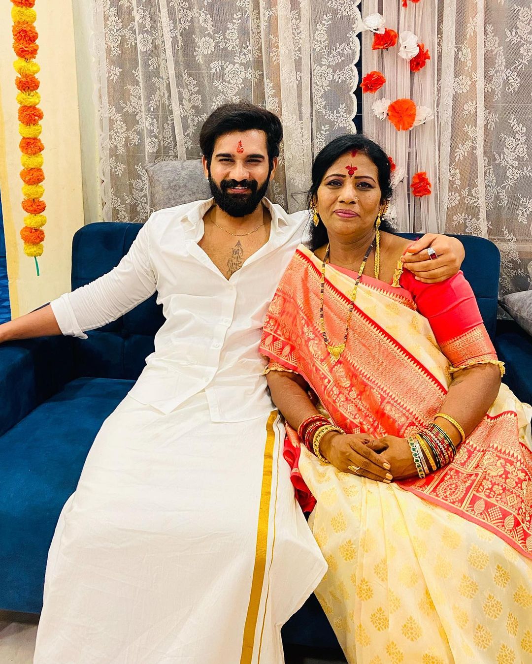 Akhil Sarthak in white dress with his mother