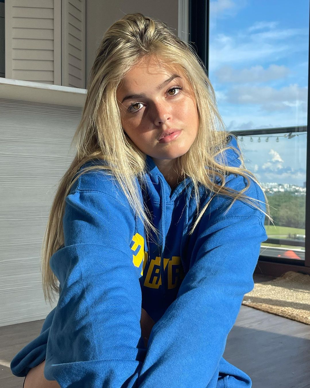 Kayla Patterson in blue hoodie with hair open