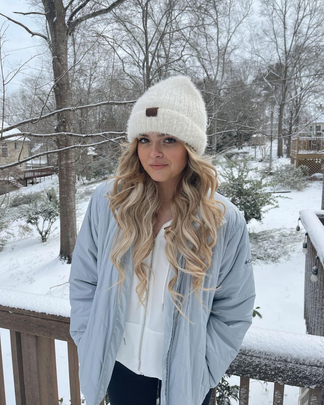 Kayla Patterson in white cap and grey jacket in a cold area