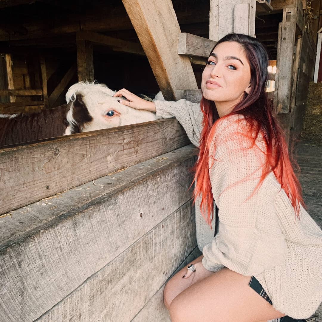 Emily Rinaudo placing her hand on an animal's forehead