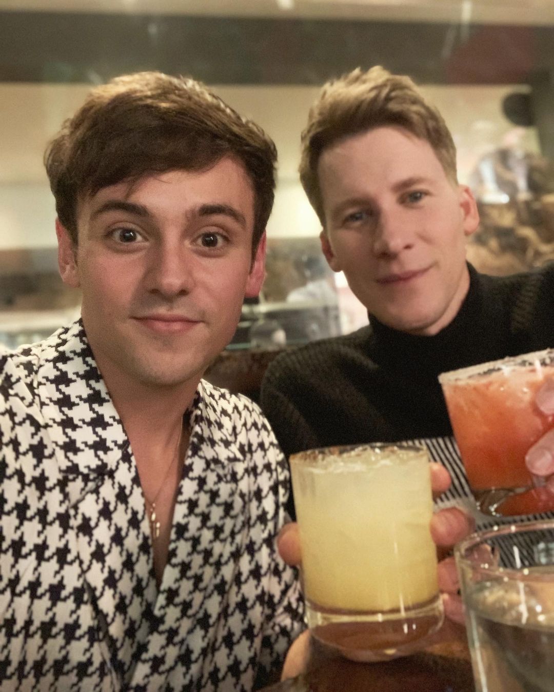 Tom Dalby and Dlance Black holding drinks in hand