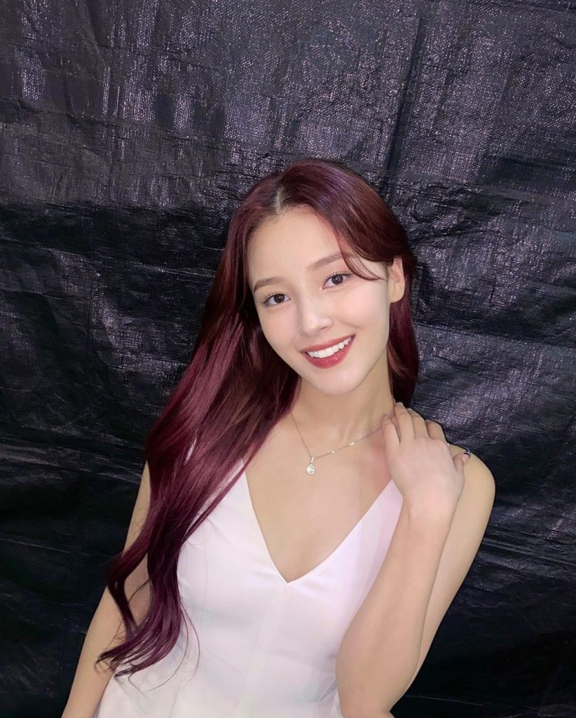 Nancy Momoland with hair open in white dress