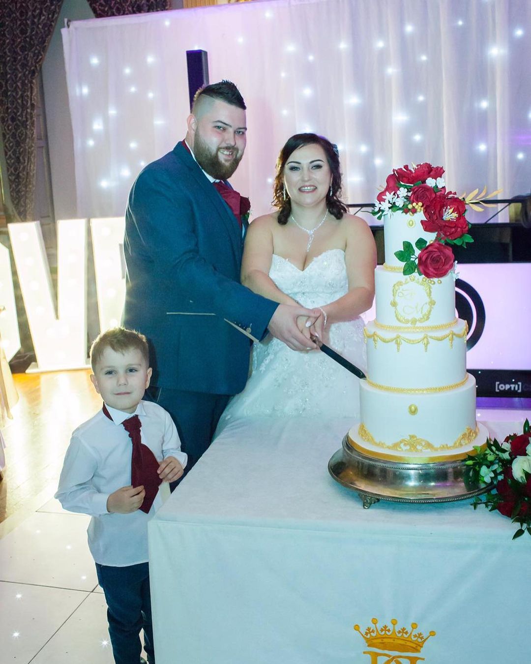 Michael Smith with wife and son cutting an anniversary cake