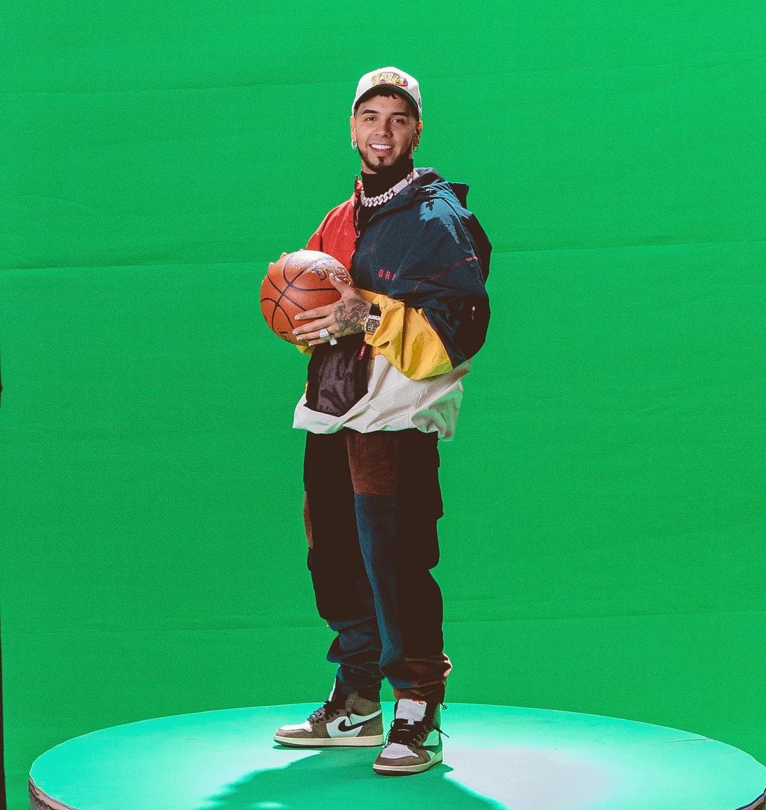 Anuel AA with a basketball in his hand