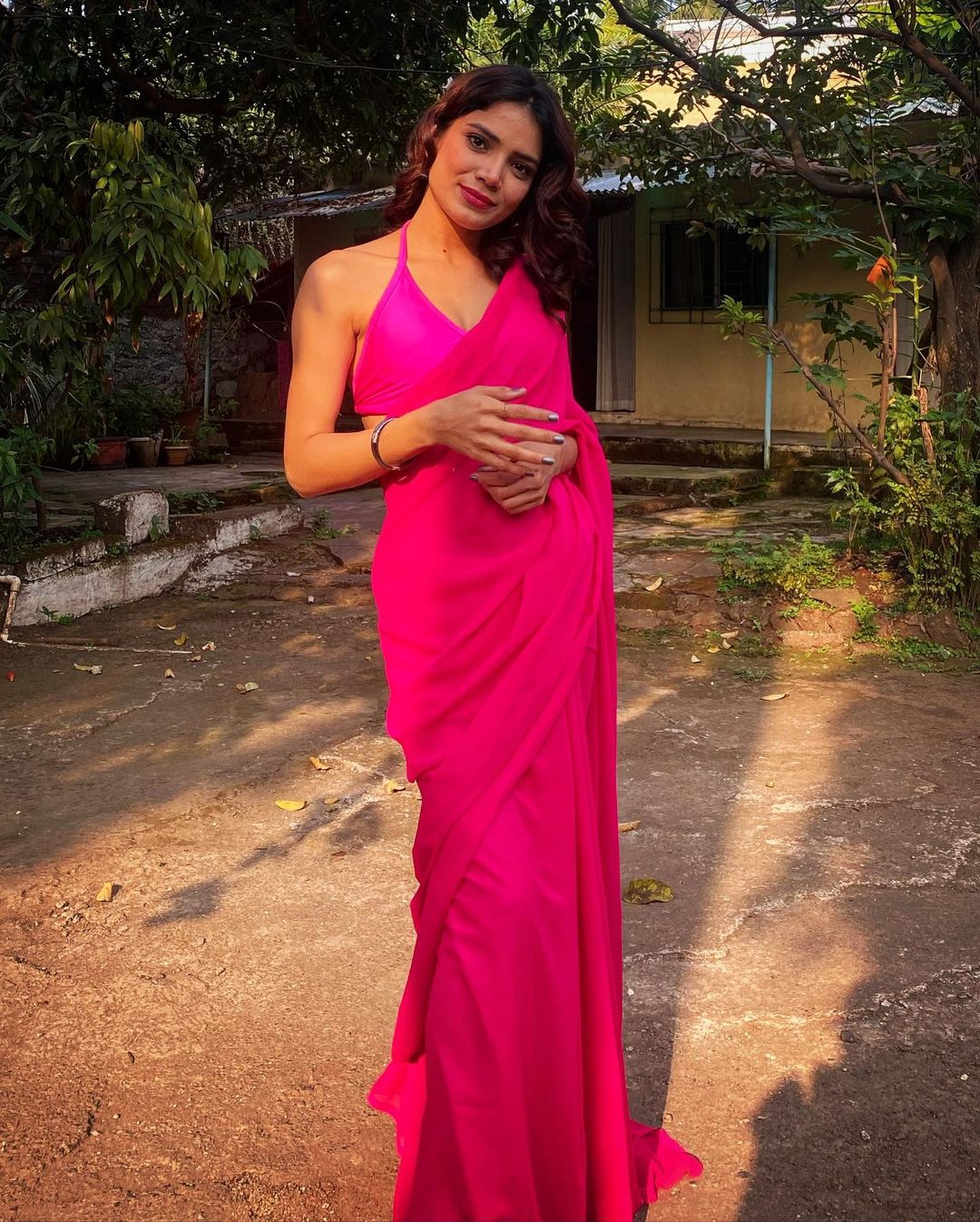 Palak Singh standing in pink saree