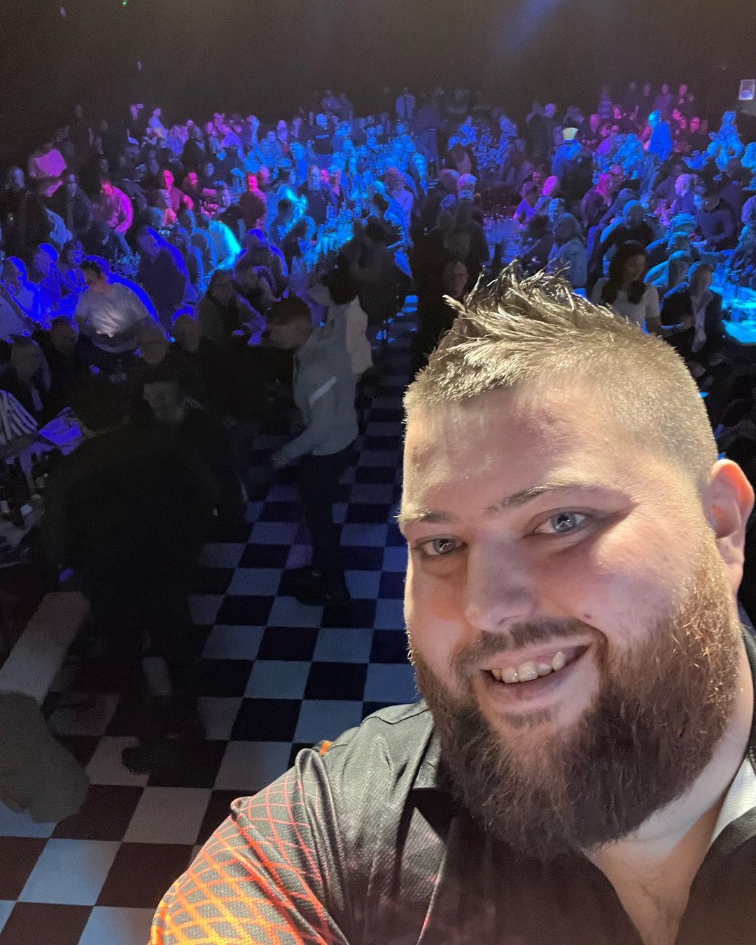 Michael Smith Darts with crowd at a night event