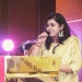 Tanu Jain addressing an event in yellow dress