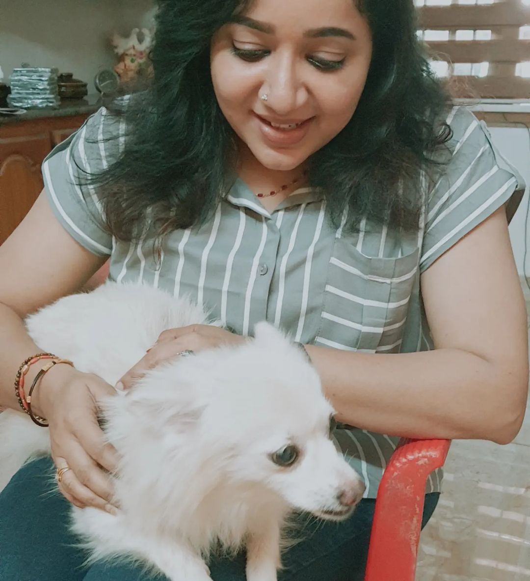 Chandra Lakshman with a white puppy