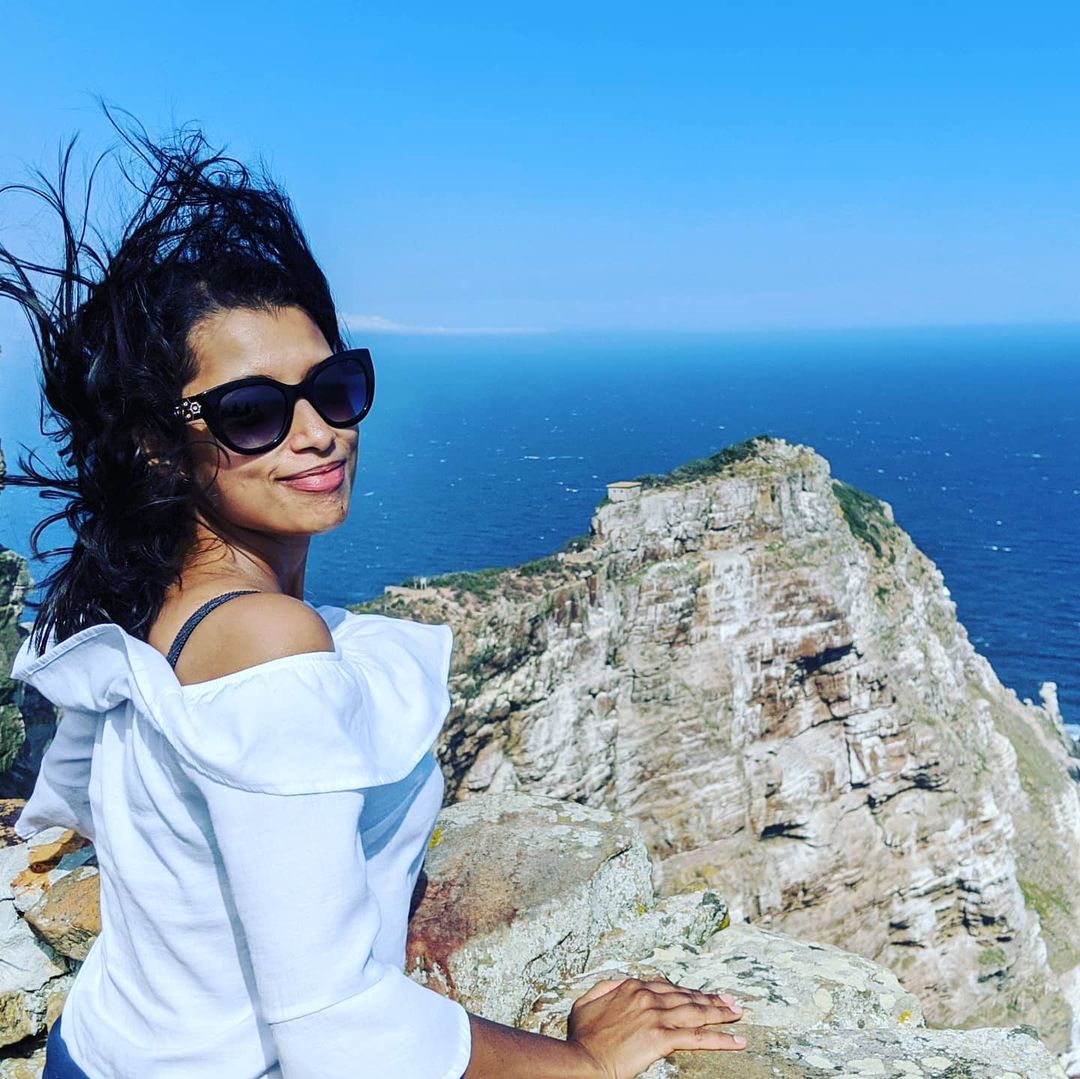 Luxmy Gopal in white top enjoying a seaview